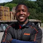 A man standing in front of a truck.