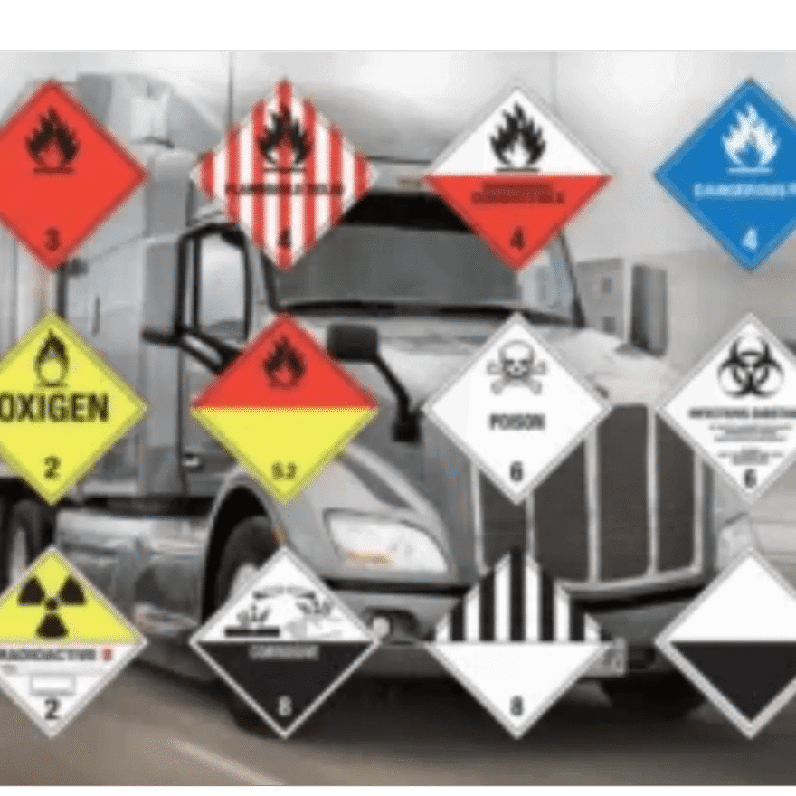 A truck with many different hazard signs on it.