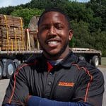 A man standing in front of a truck.